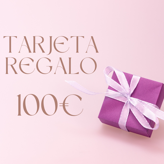 Tarjeta regalo bienestar de 100€ presentada en una caja morada con cintas de seda en un fondo rosa